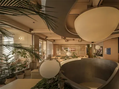 A large, open restaurant space with a high ceiling, circular design, and natural light, featuring wood furniture and decor
