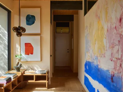 Cozy living room with a blue and white color scheme, hardwood floor, and natural light from a window