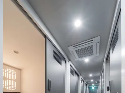 Gray hotel room floor plan with a bed on the left, a desk in the center, and a closet on the right