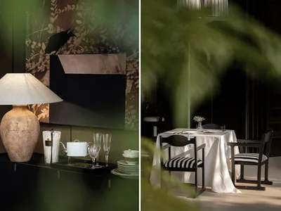 Black and white dining room with a table, chairs, vase, and lamp, featuring an elegant and sophisticated atmosphere