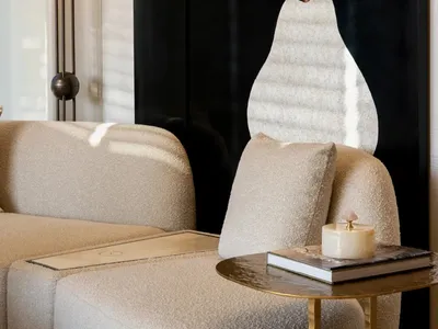 Cozy living room with a black and white color scheme, featuring a couch and chair in a comfortable and inviting arrangement, with soft and diffused lighting
