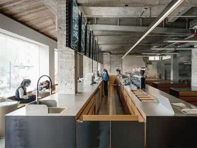 A bustling restaurant with a stainless steel counter, modern industrial design, and a lively atmosphere
