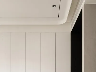 A cozy bedroom with a large wooden cabinet and a bed, featuring a warm and natural design