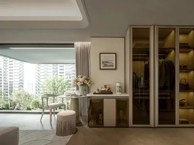 A well-lit living room with a couch, chair, dining table, and decorative elements, featuring wood and glass materials