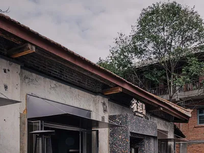 含石牆、木製家具和自然材料的戶外餐廳，營造出舒適和親切的氛圍