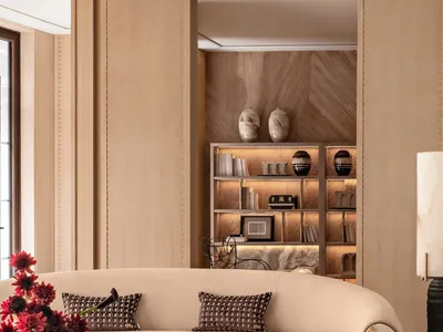 Comfortable living space with a large white couch, coffee table, fireplace, and decorative items, well-lit and inviting