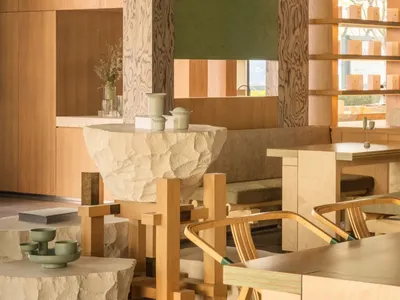 Warm and inviting dining space with wooden furniture, natural light, and modern design