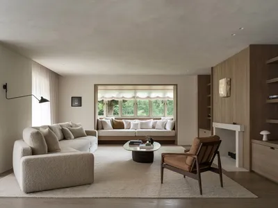 Cozy living room with a brown couch, a chair, a coffee table, and a fireplace, creating a warm and inviting atmosphere
