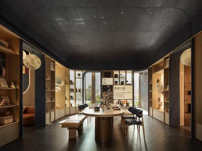 Cozy dining space with a round table, blue walls, and comfortable chairs, surrounded by books and additional seating