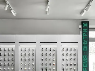 A well-lit store display featuring a collection of watches on a table and shelves, with a sophisticated and elegant atmosphere