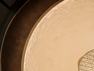 Dining area with a white ceiling, decorative design, and a round light fixture, surrounded by a dining table and chairs