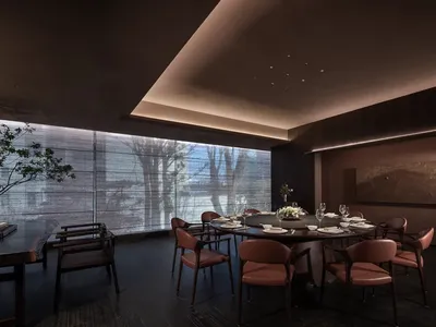 Cozy dining room with a wooden table, dim lighting, and elegant decor