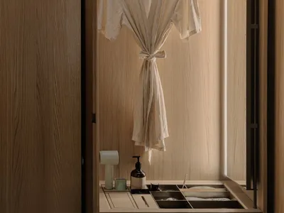 Bathroom with a wooden cabinet, white robe, and natural ambiance