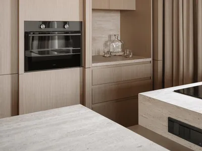 Modern kitchen with wooden cabinets, a black oven, and a bottle on the countertop, featuring a clean and minimalist design with soft, warm lighting