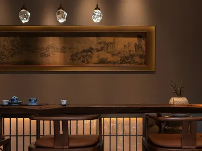 A warm and inviting dining area with a wooden table and chairs, surrounded by soft and diffused lighting
