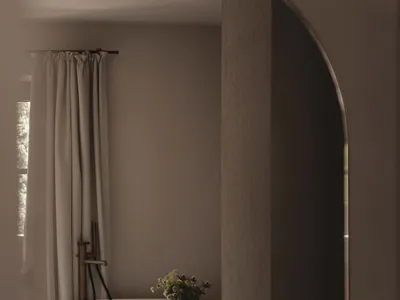 Dimly lit bathroom with a wooden floor, a bathtub, a sink, and a vase of flowers