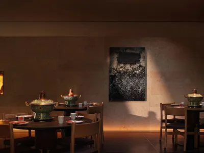 Warm and inviting dining space with a large wooden table, stone walls, and a mix of natural and artificial lighting