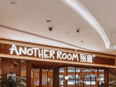 A well-lit restaurant with modern design, marble flooring, and wooden furniture, creating an inviting and comfortable atmosphere