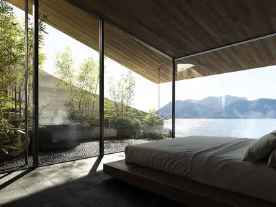 Bright and inviting bedroom with a large bed, natural light, and a view of the outdoors through a large window
