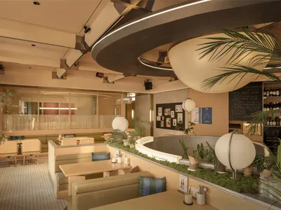 cozy restaurant interior with a circular dining table, potted plants, and a mix of natural and artificial lighting