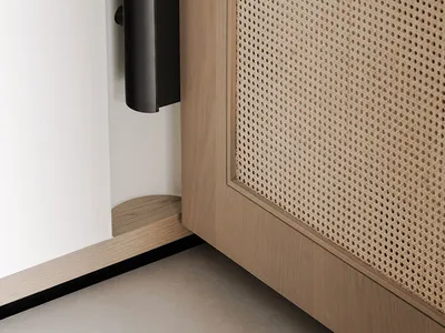 Cozy living space with a wooden door, speakers, and dim lighting