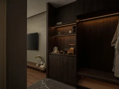 Cozy living room with wooden floors, walls, and furniture, featuring a wooden cabinet and a TV mounted on the wall