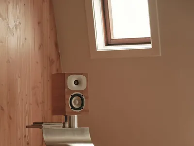 Bathroom with a wooden bench, sink, and window, featuring natural light and a warm atmosphere