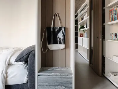 A minimalist bedroom with a bed, bookshelf, and closet, featuring white walls, a clean and bright appearance, and a modern style