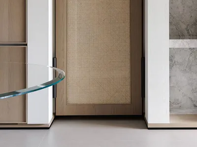 A modern kitchen with a wooden door and window, featuring a sink and natural light from the window