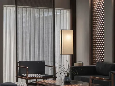 Cozy living room with a couch, chair, and table on a hardwood floor, soft and diffused lighting, and neutral colors