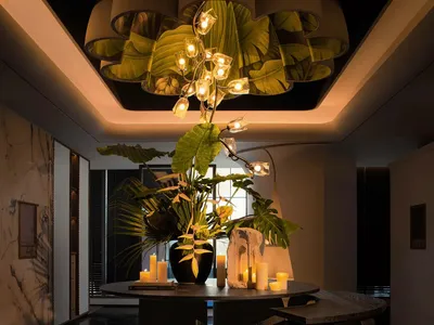 Sophisticated dining space with a black and white color scheme, a large chandelier, and decorative elements