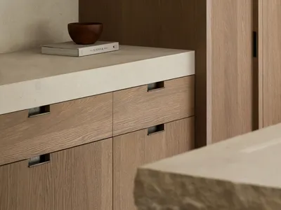 A modern kitchen with wooden cabinets and a stone countertop, creating a warm and inviting atmosphere