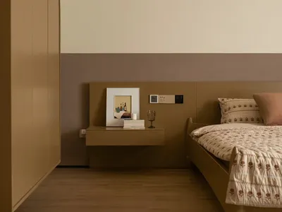 Cozy bedroom with a brown bed, dresser, and picture, set against a brown background, with a white comforter and dim lighting