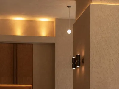A dimly lit restaurant interior with wooden tables, chairs, and decorative items, creating a warm and inviting atmosphere for guests