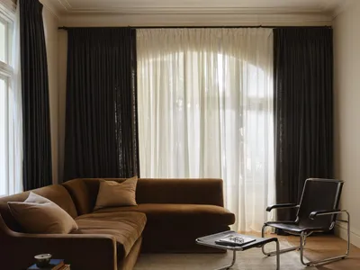 Cozy living room with a brown couch, chair, and coffee table, well-lit with natural light and hardwood floor