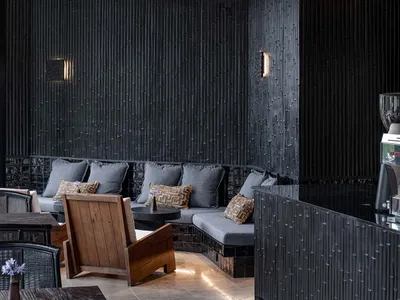 A black and white living room with a couch and chair in the center, creating a cozy and inviting atmosphere