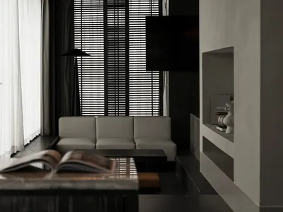 A well-lit living room with a white couch, a black chair, and a television on a stand, set against a black and white color scheme