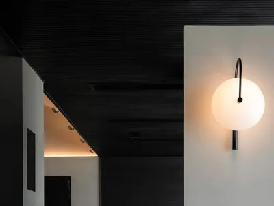 A black and white living room with a couch, chair, and bed, arranged to create a cozy atmosphere
