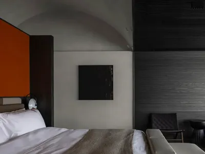 Cozy modern bedroom with a black and white color scheme, wood furniture, and dim lighting