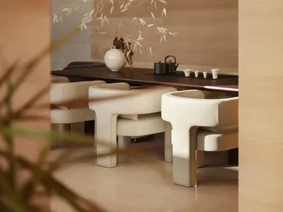 A well-lit restaurant with a wooden table and chairs, surrounded by a vase, in a modern and elegant setting