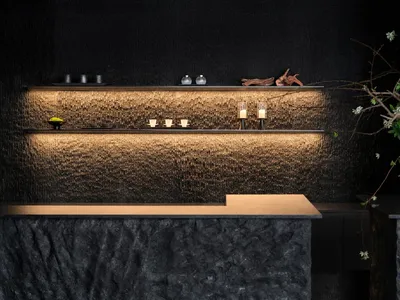 Elegant kitchen with a marble countertop, candles, a vase, and a bowl, creating a sophisticated atmosphere