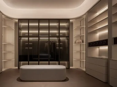 A well-lit bedroom with a bed, bench, and closet, featuring wood and fabric materials in a cozy and inviting space