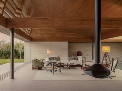 Cozy living space with a fireplace, modern furniture, and natural light from windows
