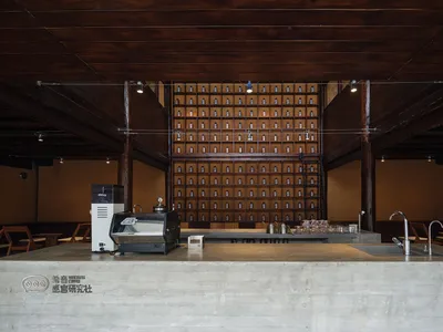 現代廚房，設有流理台及整面玻璃罐牆，營造機能與視覺兼具的空間，搭配均衡照明