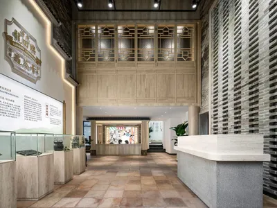 A well-lit room with a wooden floor, marble counter, glass display case, wooden ceiling, and stone wall, showcasing art and artifacts