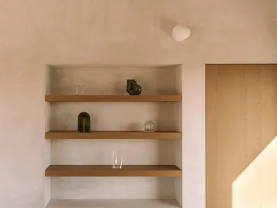 Cozy living space with a wooden bookshelf, natural light, and various decorative items