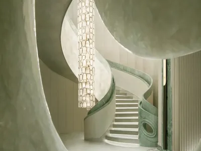 A dimly lit, curved marble staircase dominates the space, with no other objects or distractions visible