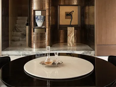 Dining room with a glass chandelier, a dining table, and various decorative items, set in a well-lit space with natural light from a window
