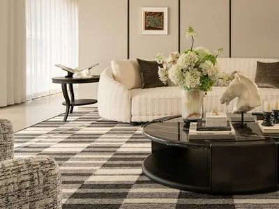 Comfortable living space with a couch, chair, and dining table, decorated with a vase of flowers and well-lit