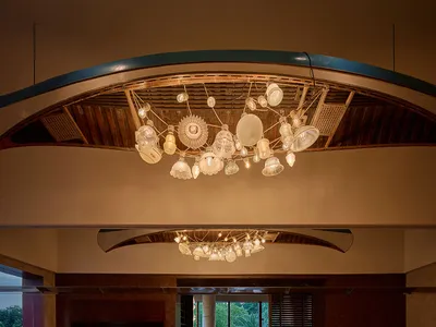 A warm and inviting restaurant interior with wooden tables and chairs, set with various items and pleasant lighting